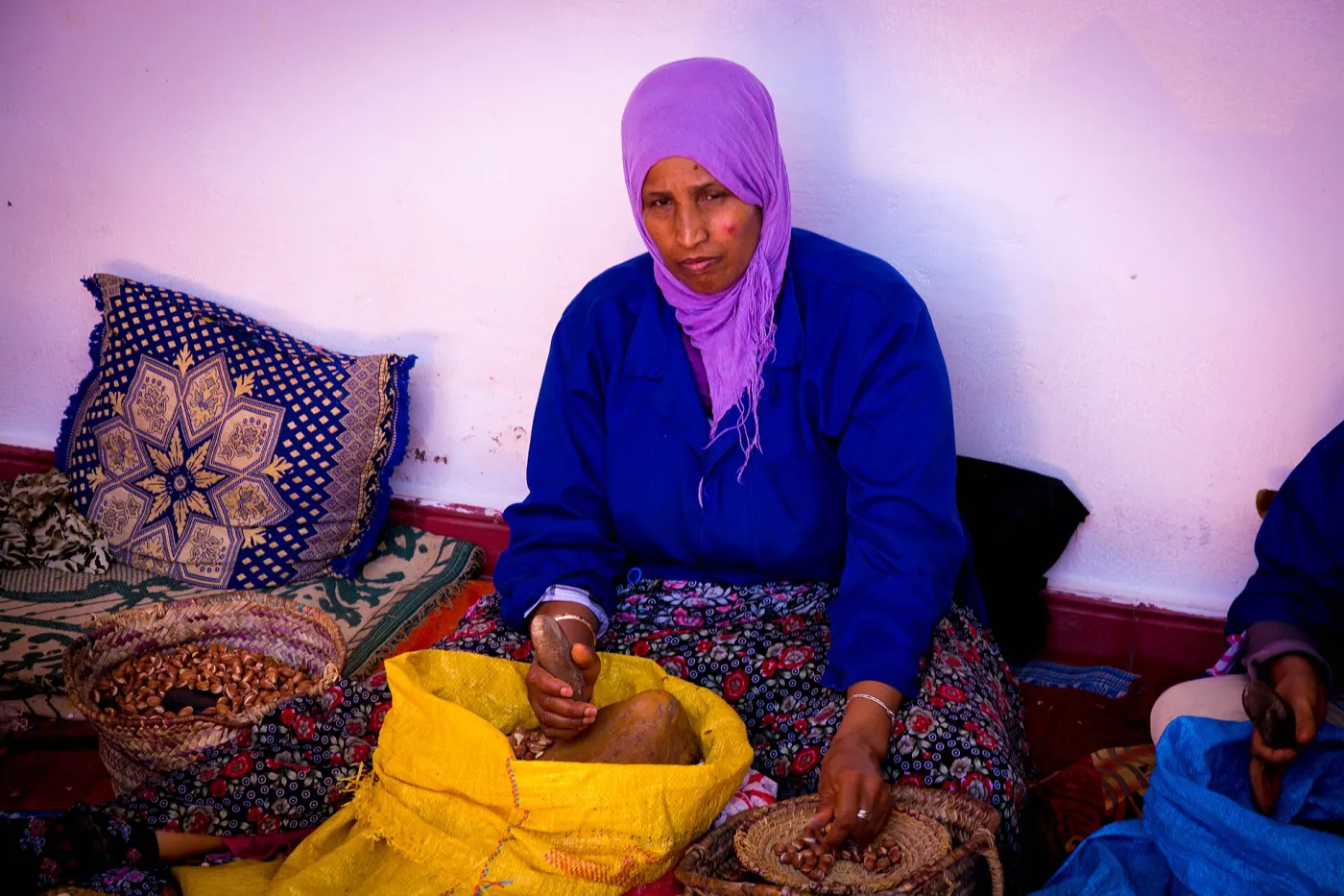 Women cracking argan nuts at an argan oil cooperative