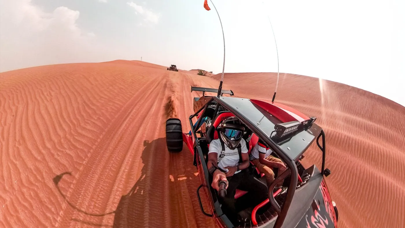 Dune buggy driving over sand dunes