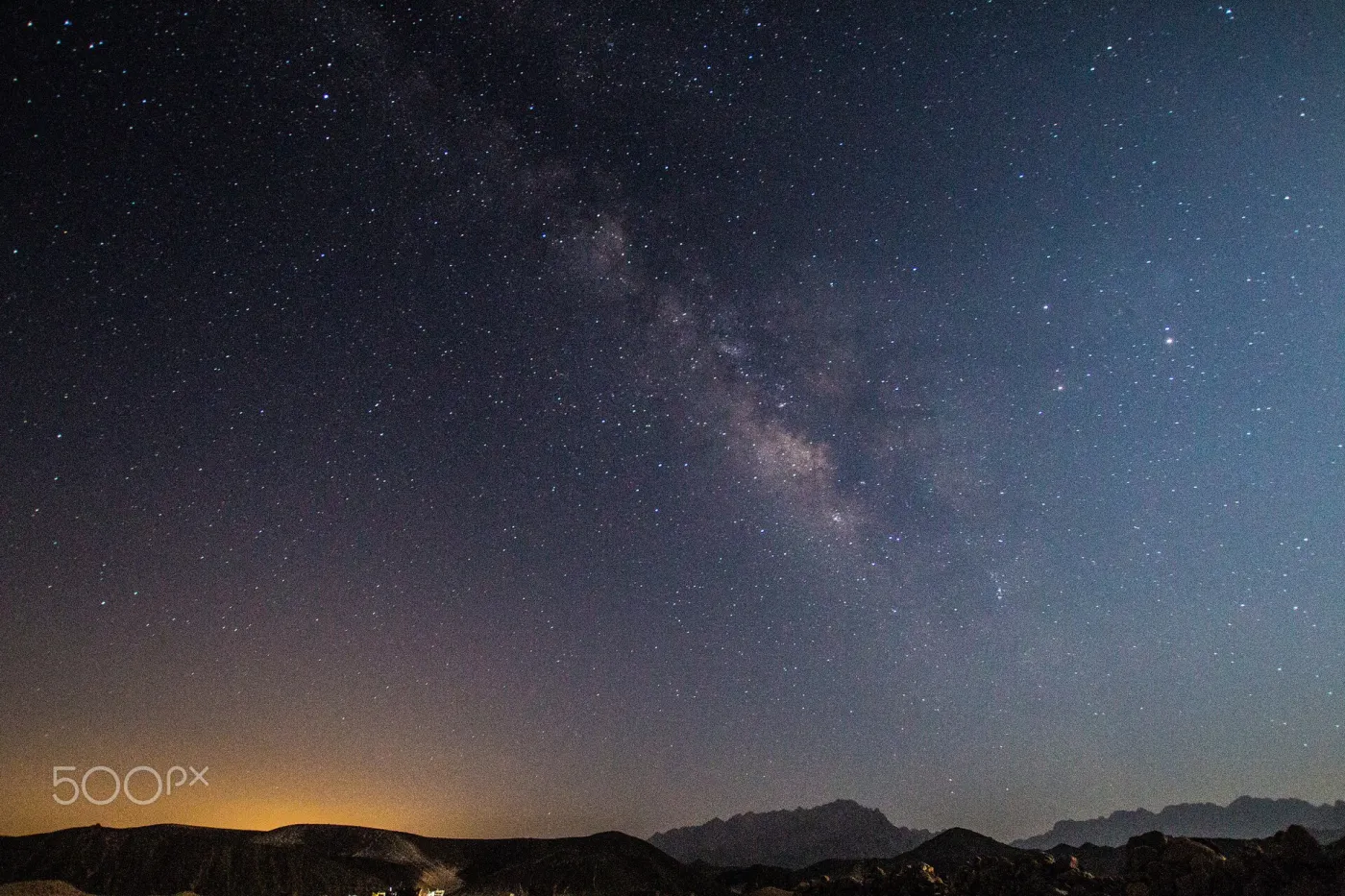 Milky Way over a dark desert horizon