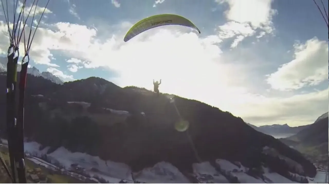 Paraglider flying above the Toubkal massif in the High Atlas